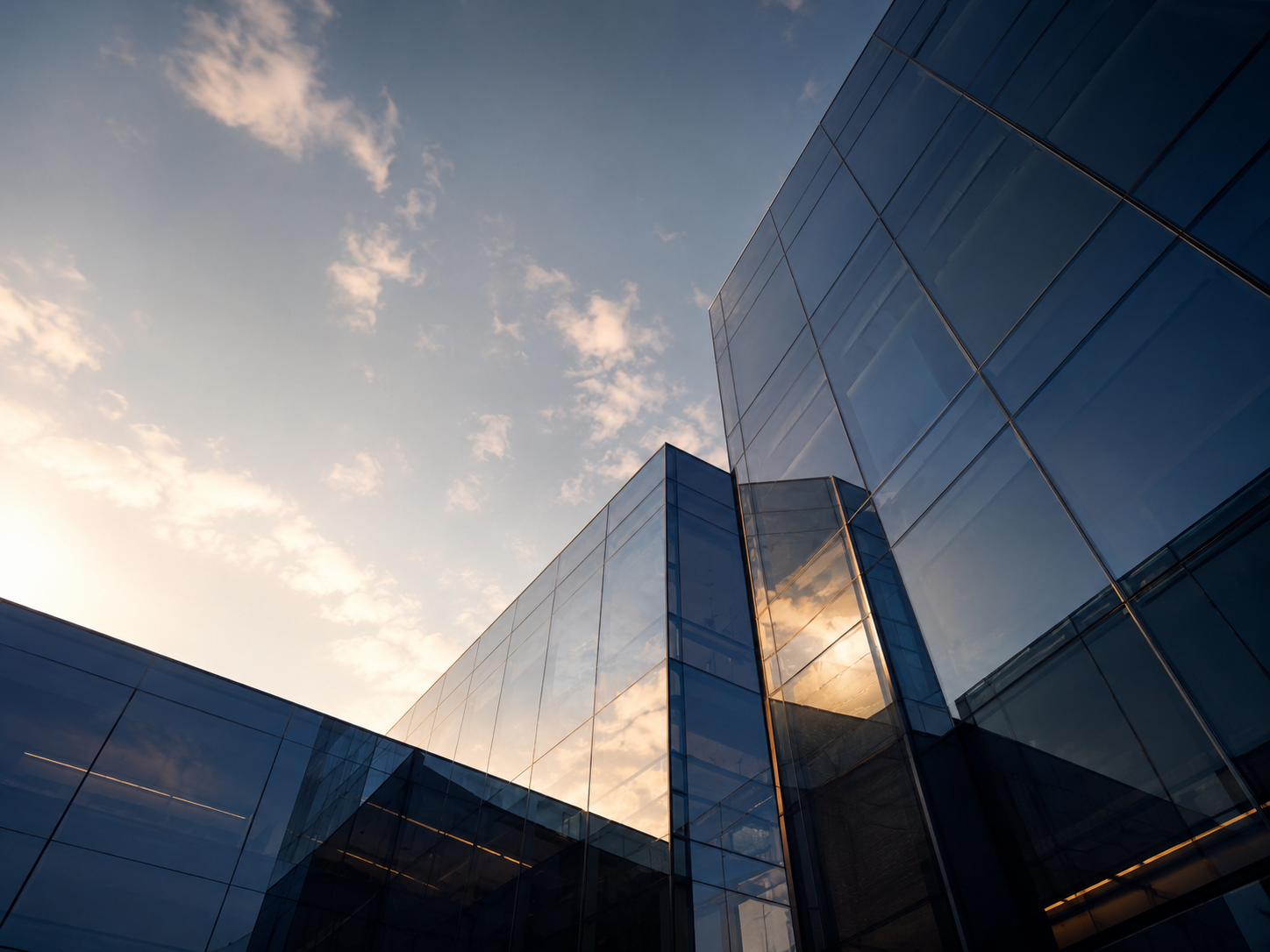 Modern architectural glass building against sky